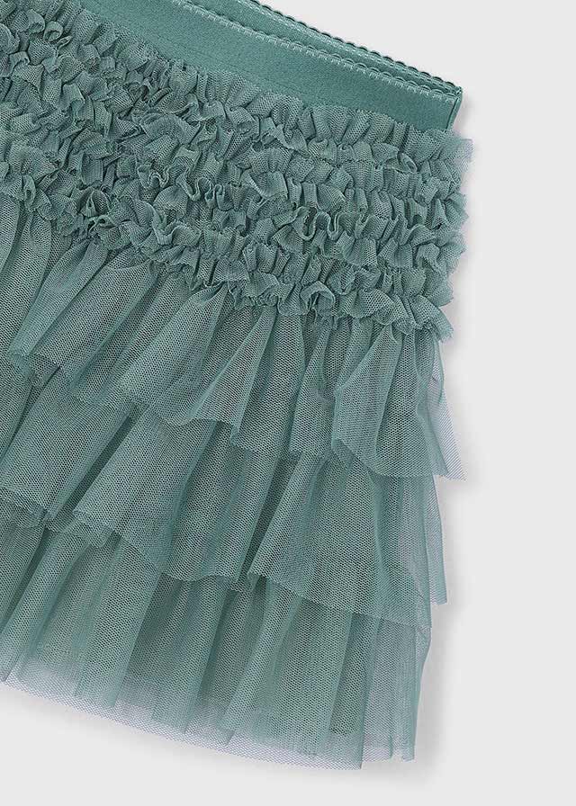 Dettaglio della vita elasticizzata e delle balze in tulle della gonna Mayoral verde salvia